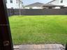 Rear yard featuring a paved stone patio, sod lawn, and perimeter privacy fencing