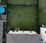Fenced backyard featuring a grass lawn and paver patio
