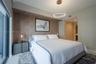 Textured accent wall with a recessed alcove, contemporary circular LED pendant light, and dual cylindrical glass-shade hanging pendants