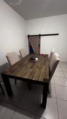 Neutral ceramic tile flooring and sliding wood-finish barn door with black iron hardware