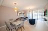 Open-concept living space featuring wood-finish flooring, floor-to-ceiling windows, modern geometric pendant lighting, an industrial-style chandelier,