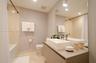 Floating vanity featuring a rectangular vessel sink and polished chrome faucet, paired with a large wall-mounted mirror, mosaic tile wall accents, and