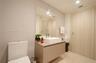Floating vanity featuring a flat-panel cabinet, rectangular vessel sink, and chrome faucet, complemented by a large frameless wall mirror and wood-fin
