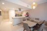 Kitchen featuring a breakfast bar, stainless steel range hood, recessed lighting, and geometric-style chandelier