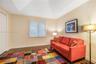 Vaulted ceiling, wood-finish flooring, and window shutters