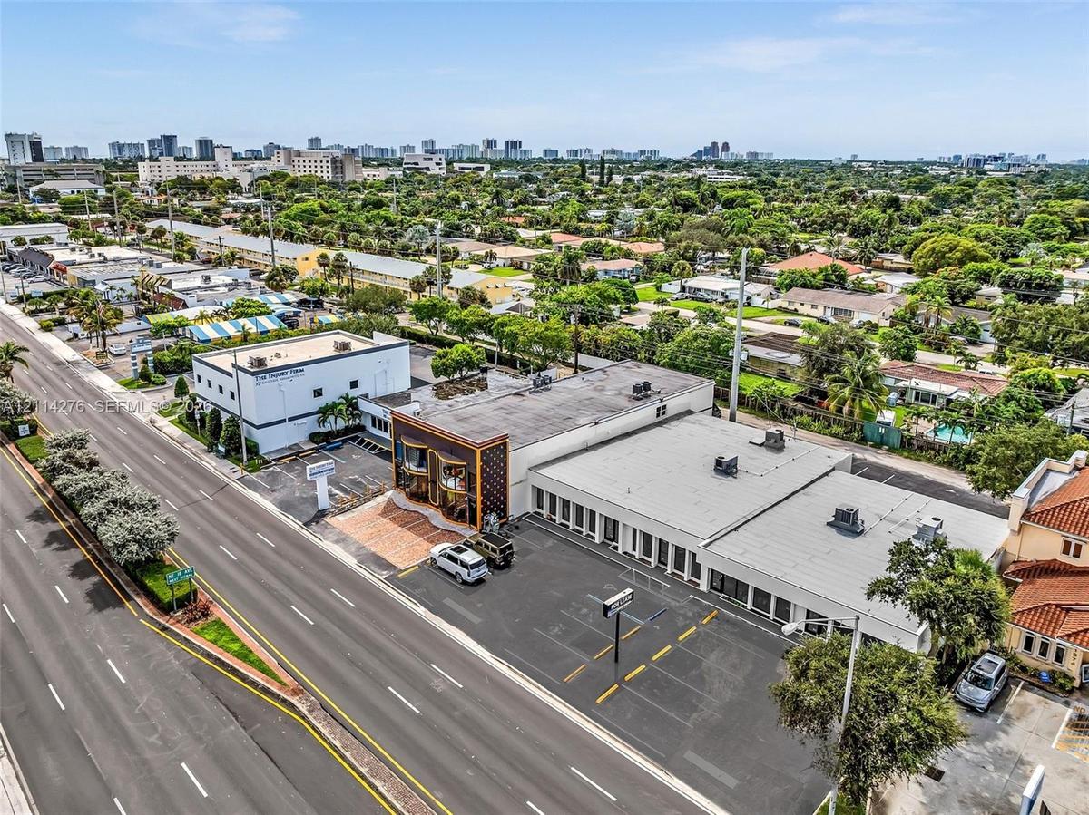 Commercial property featuring paved surface parking, multi-level exterior structure, and prominent road frontage