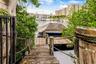 Private wooden dock featuring rope handrails, timber pilings, and direct water access