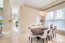 High ceilings, polished stone flooring, custom architectural pendant lighting, and oversized windows with drapery