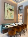 Vertical wood-slat wall paneling, built-in recessed arched shelving with integrated lighting, and terrazzo flooring