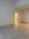 High-ceiling interior featuring large-format tile flooring and neutral wall finishes