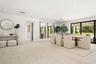 Large-format tile flooring, recessed ceiling lighting, and expansive glass sliding doors