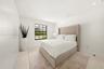 Bedroom 3 Minimalist room featuring smooth white walls, recessed ceiling lighting, light-toned tile flooring, and a black-framed grid window