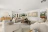 Open floor plan featuring recessed lighting, smooth white walls, light-toned flooring, and neutral finishes