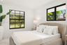 Bedroom 2 Neutral wall finishes, recessed lighting, and black-framed windows featuring multi-pane grids