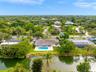 Waterfront property featuring a swimming pool, covered concrete patio, and direct canal access with bulkhead