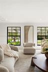 Black-framed multi-pane windows and recessed ceiling lighting
