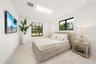 Skylight, large-format tile flooring, and multi-pane windows with black frames
