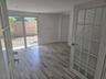 Interior space featuring wood-finish flooring, recessed lighting, and a multi-lite door with integrated blinds