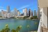 Private balcony featuring a metal railing and panoramic scenery of the waterfront and urban skyline