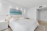 Neutral-toned wood-finish flooring, recessed ceiling lighting, and solid-core interior doors