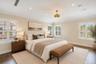 Interior space featuring wood-finish flooring, recessed lighting, crown molding, plantation shutters, and a decorative pendant light fixture