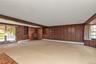 Lower Level Den with Wood Burning Stove and Door to Back Patio