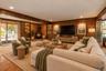 Virtually staged Lower Level Den with Staged Wood Burning Stove and Door to Back Patio