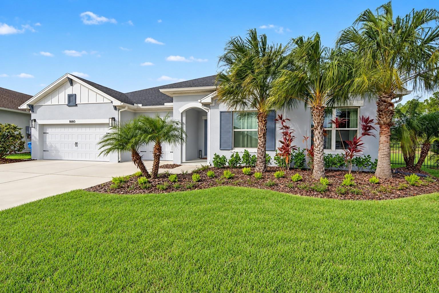 Covered entry with resort-style landscaping