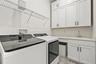 Walk in laundry room with additional storage