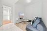 Polished stone flooring, wood-finish flooring, and wall-mounted white cabinetry
