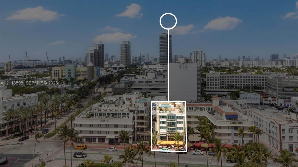 Aerial perspective of mid-rise property featuring a rooftop terrace with pool and multi-level balconies