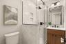 Guest bathroom with tiled shower and beautiful vanity and lighting.