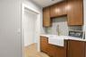 Laundry room with farm sink and custom cabinetry.