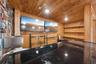 Looking into the bar area with fixed shelving, epoxy bartop and sink with 2 flat screen tv's included.  Everything you need to start watching the big 