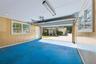 This view shows the long extended driveway that could hold 8 cars ! views of the screen porch and hot tub