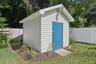 Workshop / Shed.  with an irrigation well and 4 zone sprinkler set up behind.