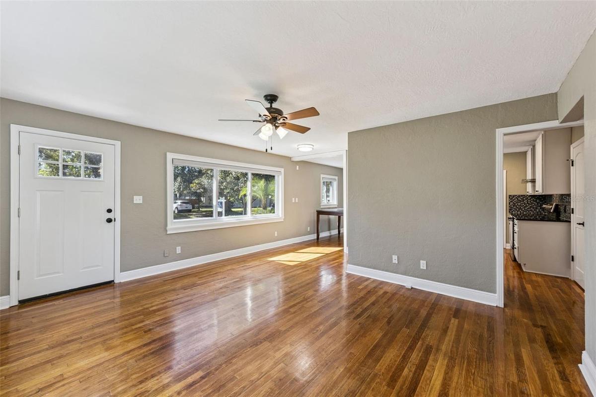 Original hardwood floors and new windows make for a great family room