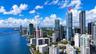 High-rise glass facade skyscraper situated in a dense urban waterfront setting