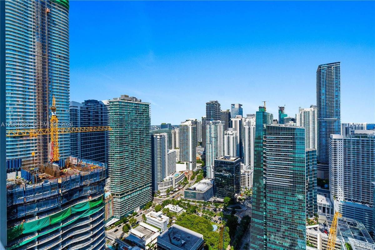 Panoramic urban skyline featuring high-rise glass-facade buildings, expansive structural density, and clear horizon visibility