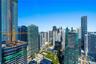 Panoramic urban skyline featuring high-rise glass-facade buildings, expansive structural density, and clear horizon visibility