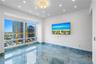 Floor-to-ceiling windows, polished stone flooring with veining, recessed lighting, and wall-mounted central ceiling fixture