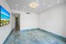 Polished blue stone flooring, recessed ceiling lighting, and a central flush-mount light fixture