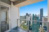 Private balcony featuring stone tile flooring and a glass-paneled railing with a metal frame