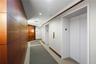 Elevator lobby featuring smooth wood-paneled walls, double-door entryway, and recessed ceiling lighting