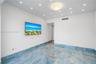 Polished stone flooring with blue and gold veining, recessed lighting, and a central flush-mount ceiling fixture