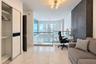 Large-format light-toned stone flooring, floor-to-ceiling dark textured accent wall, glass-panel railing, multi-arm flush-mount ceiling lighting, and 