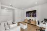 Neutral-toned room featuring wood-finish flooring, recessed lighting, and a double-door closet