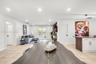 Open floor plan featuring recessed lighting, tile flooring, glass-paned double doors, and a kitchen island with vertical wood-slat detailing