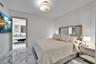 Polished stone flooring, recessed lighting, flush-mount drum fixture, and built-in mirror panel