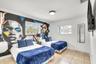 Neutral-toned tile flooring, dual windows, and ceiling-mounted light fixture